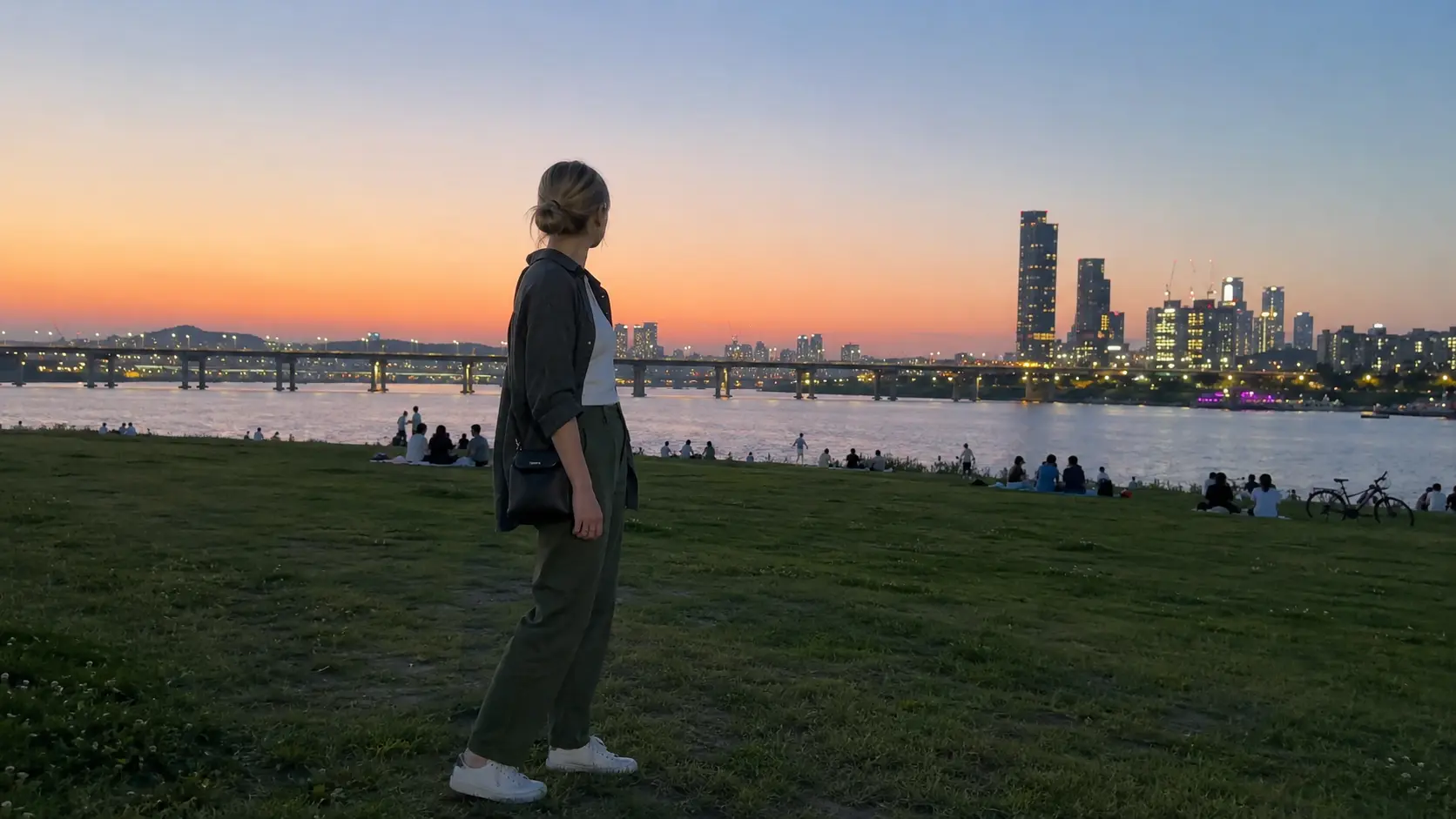 Foreigner standing on a riverside lawn at han river seoul during a summer evening in Seoul